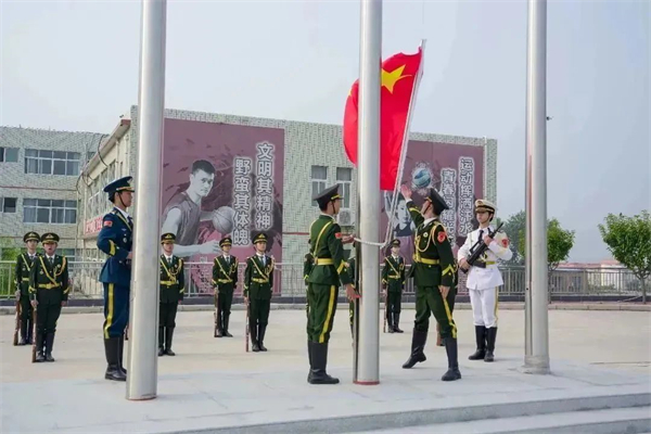 与会师生全体起立，奏唱国歌，现场举行了庄严隆重的升旗仪式.jpg